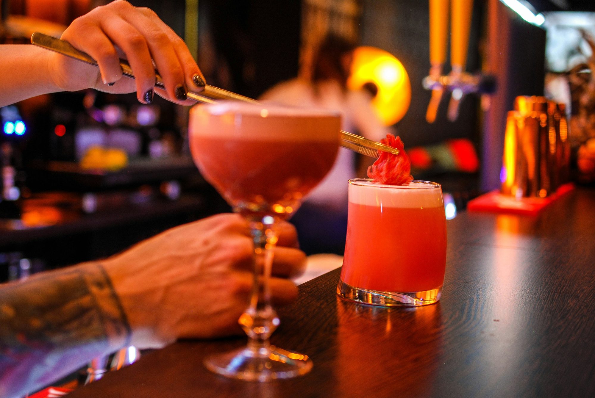 A Bottega Bar bartender pouring a drink
